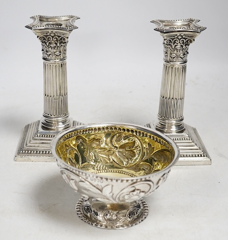 A pair of Edwardian dwarf Corinthian column silver candlesticks, by Harrison Brothers and Howson, Sheffield 1908 (loaded), 15.5cm high and a Victorian silver pedestal sugar bowl by Jacobes J Oosterbaan, London 1878, 148g